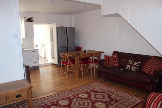 a living room with a couch and a table at Walmer House in Deal