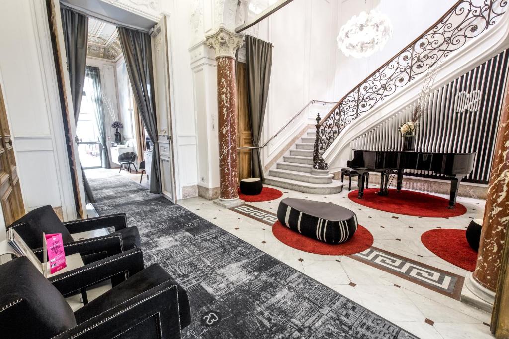 a room with a grand staircase with a piano at Hotel C2 in Marseille