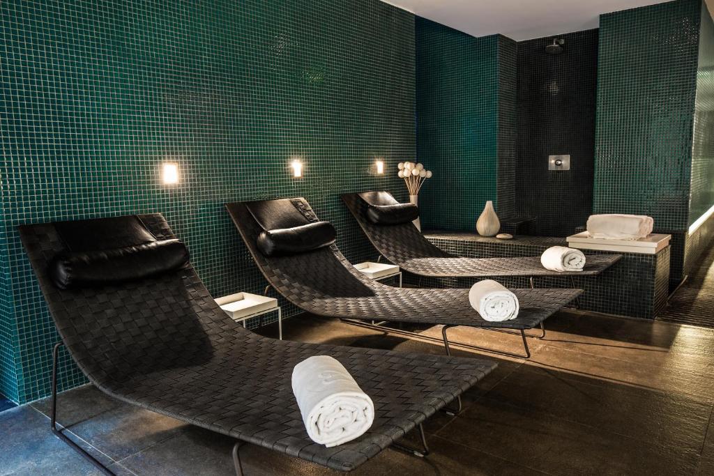a waiting room with chairs and green tiled walls at Hotel C2 in Marseille