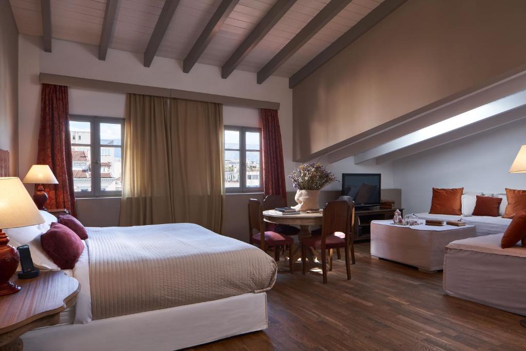 A bed or beds in a room at Emporikon Athens Hotel