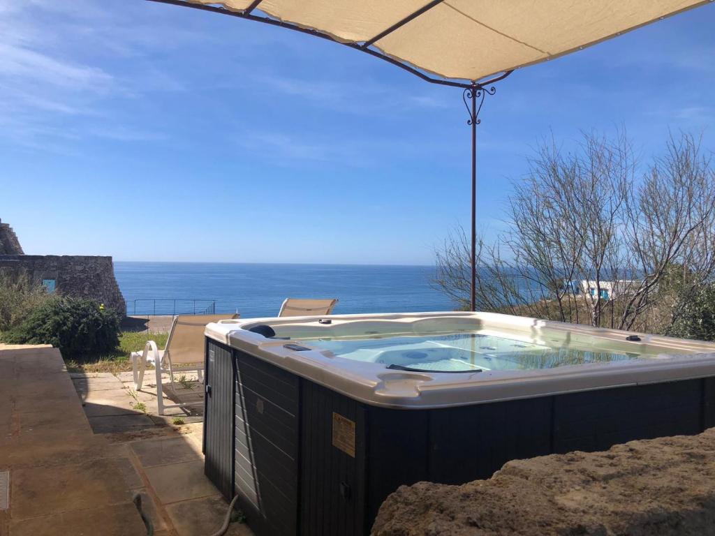 a hot tub with a view of the ocean at Villa Mariapaola in Torre Vado