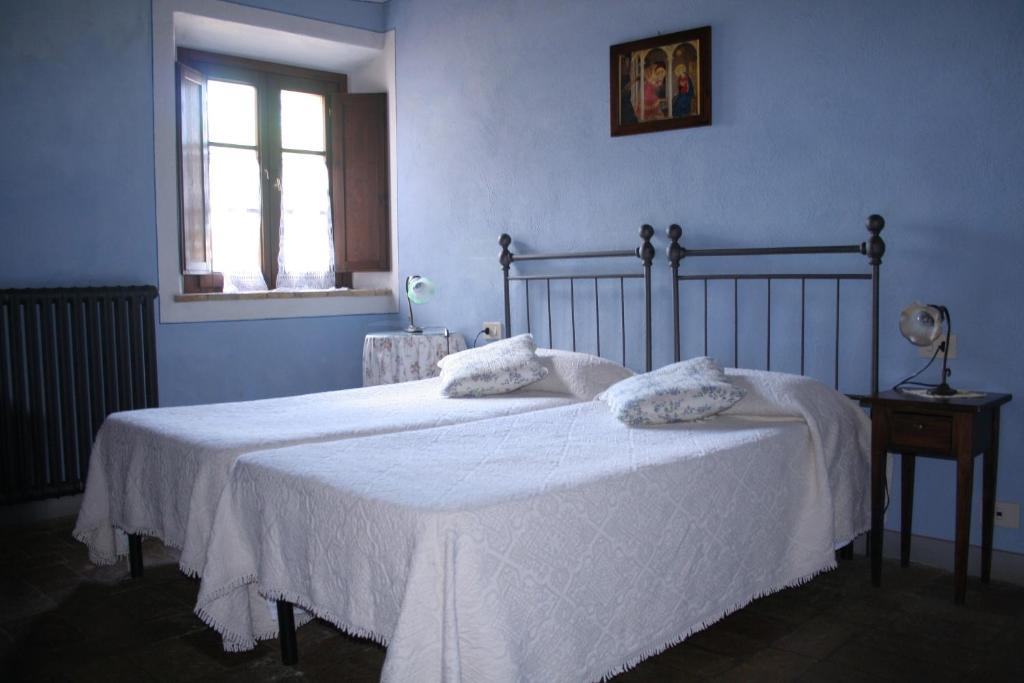 Postel nebo postele na pokoji v ubytování Podere La Casetta - Casa di Campagna