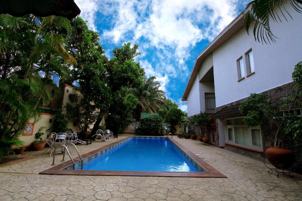 a swimming pool in the courtyard of a house at La Cour Hotels and Apartments Glover in Lagos