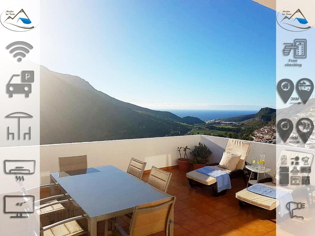 balcón con mesa y vistas al océano en Mirador del valle, en Agaete