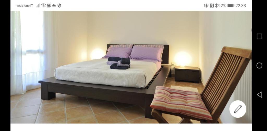 アルバタックスにあるCasa Alessandraのベッドルーム1室(紫色の枕と椅子付きのベッド1台付)