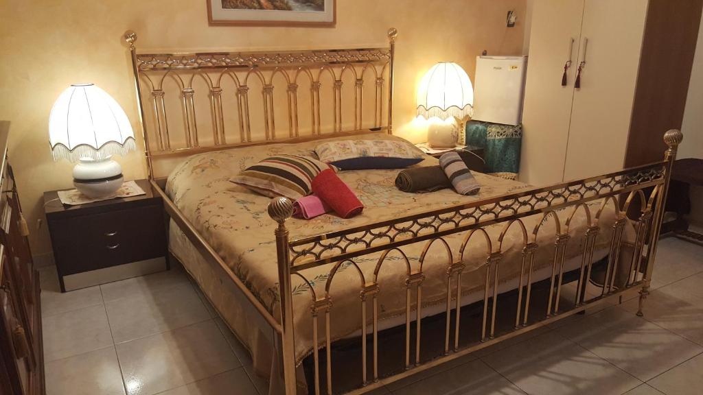 a bedroom with a large bed with two lamps at B&B United States of Europe in Catania