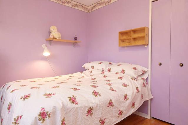 a bedroom with a bed with a white comforter and a teddy bear at Private Room near Airport in Mississauga