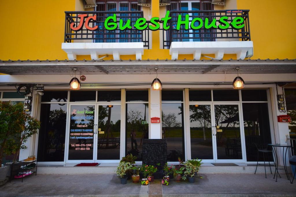 a store front with a sign for a guest house at JC Guesthouse @ Suratthani Airport in Suratthani