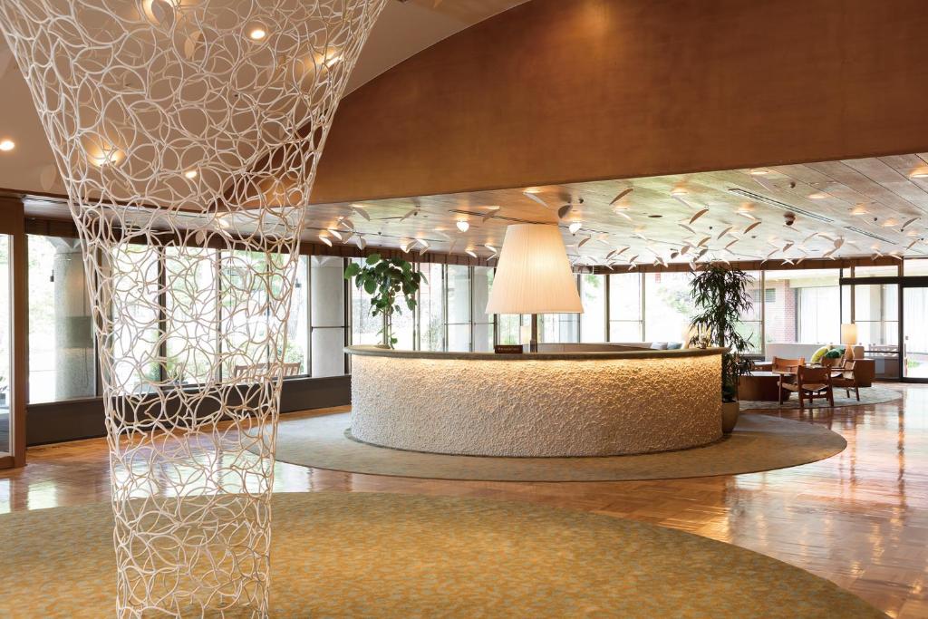 a lobby with a reception desk in a building at Karuizawa Prince Hotel East in Karuizawa