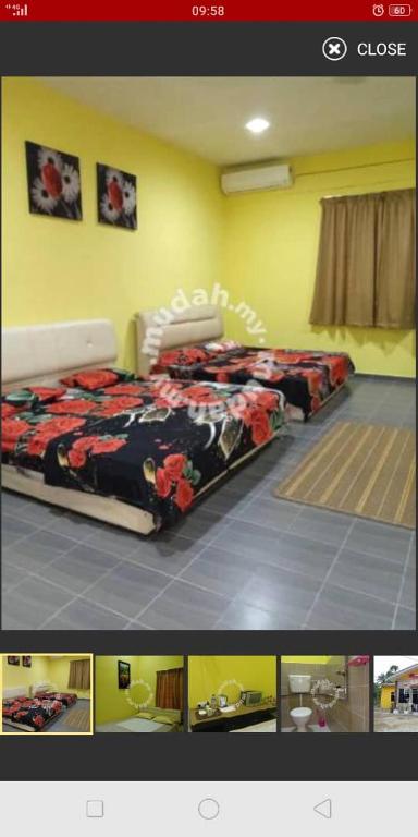 two beds are in a room with at Hotel Murah Pasir Puteh in Pasir Puteh