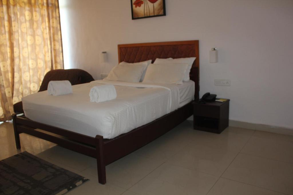 Postel nebo postele na pokoji v ubytování The Cliff Resort, Munnar