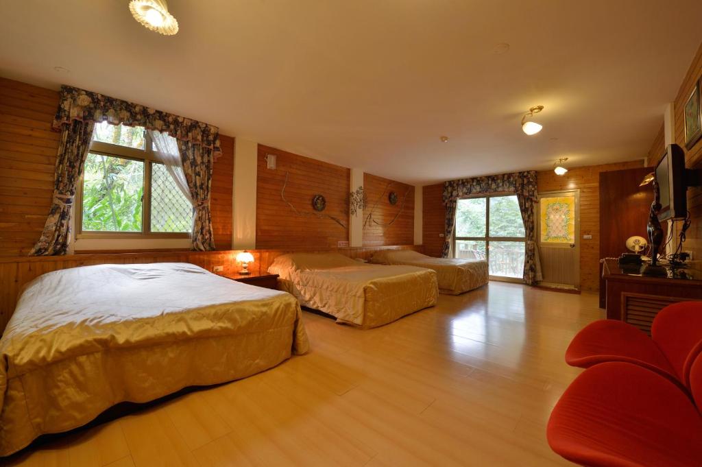 Postel nebo postele na pokoji v ubytování Shinmingshan Holiday Inn