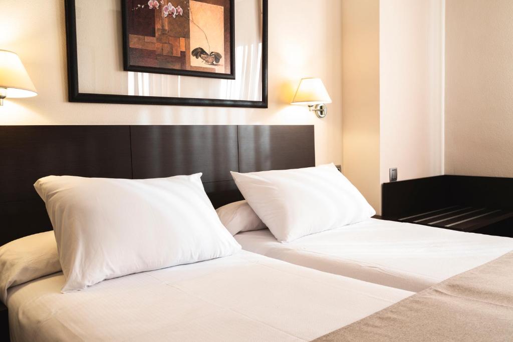 Postel nebo postele na pokoji v ubytování Hotel Cristina