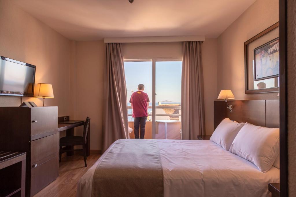Postel nebo postele na pokoji v ubytování Hotel Cristina