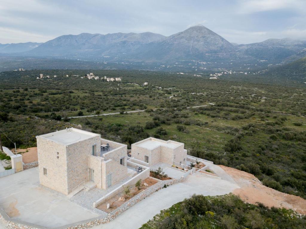 an aerial view of a house with mountains in the background at Vorino Luxury Villas in Psíon