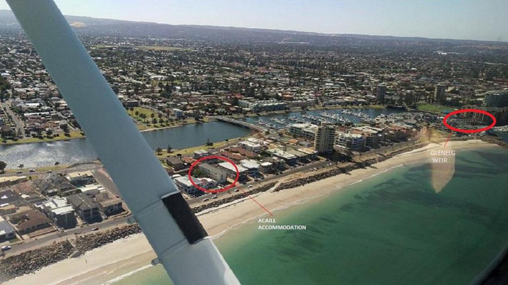 an aerial view of a beach with a boat in the water at Acaill Accommodation Esplanade Living Self Check-In Self Check-Out in Adelaide