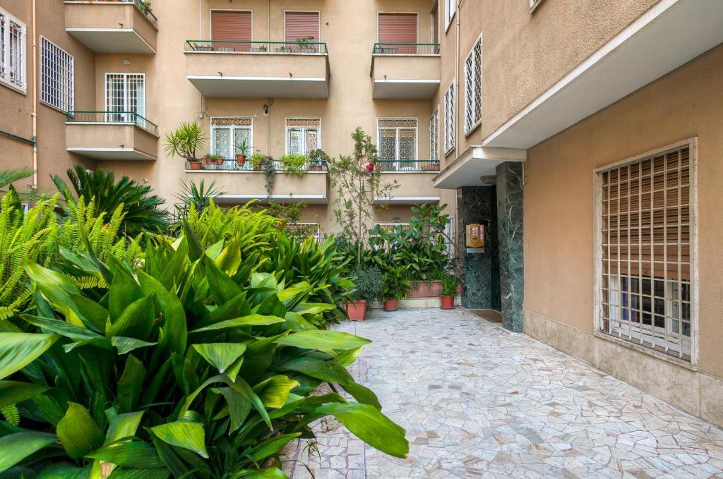 a courtyard of a building with plants in front of it at Many Days Apartments in Rome