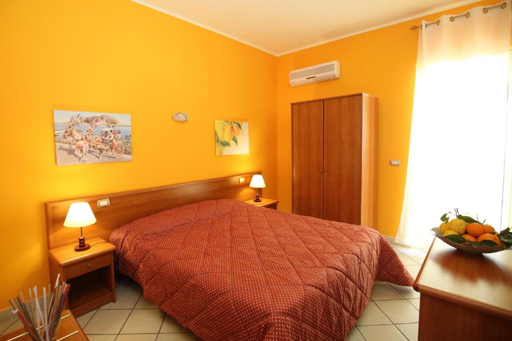 1 dormitorio con 1 cama con colcha roja en Valle D'Agrò, en Savoca