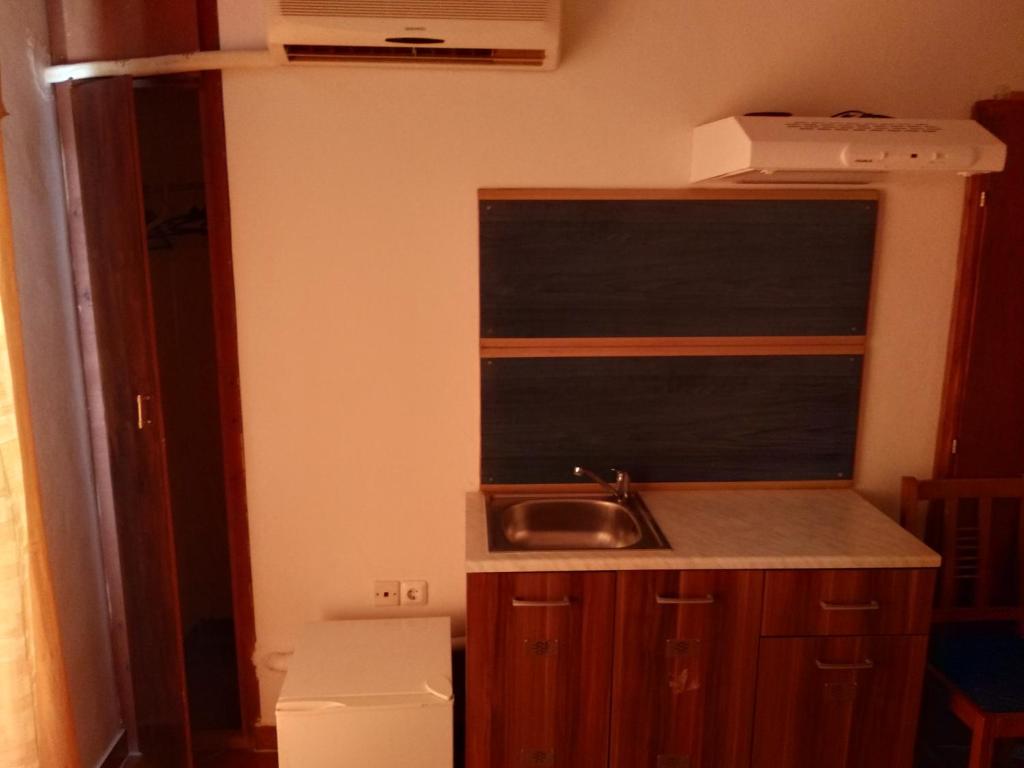 a small kitchen with a sink and a window at Atlantis in Ermoupoli