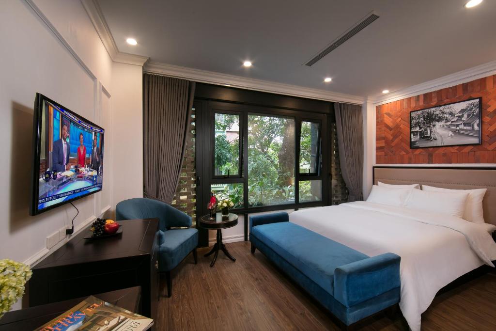 河內的住宿－Marina Hotel，一间卧室配有一张床、一张桌子和一把椅子