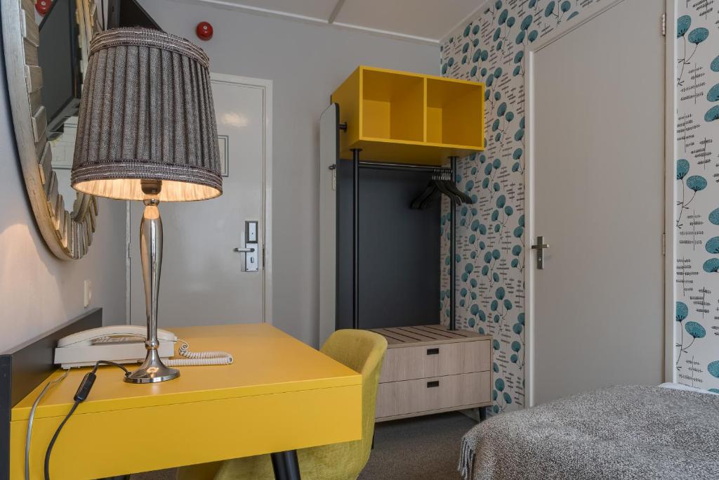 Postel nebo postele na pokoji v ubytování Hotel Op Diek