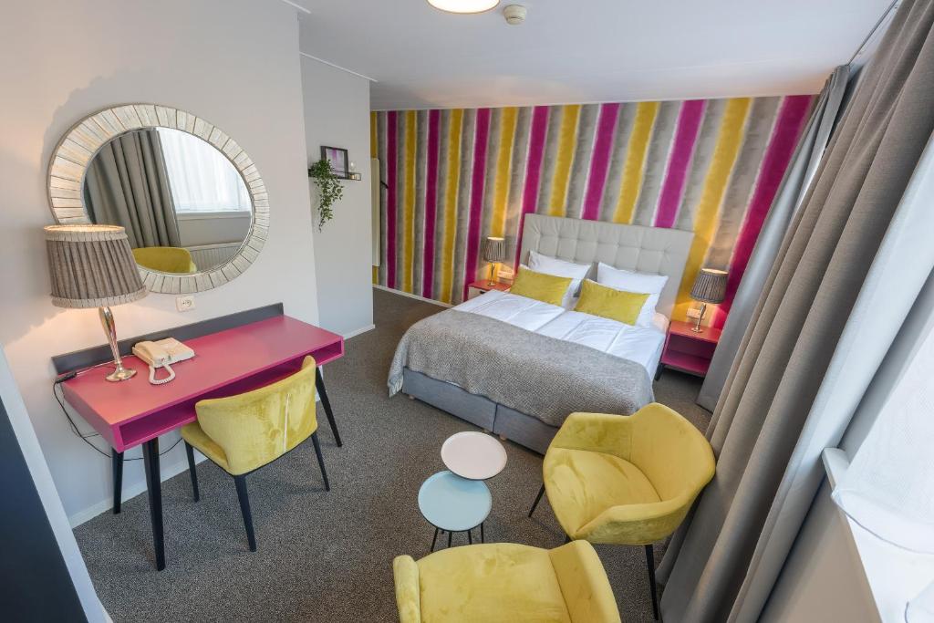 Postel nebo postele na pokoji v ubytování Hotel Op Diek