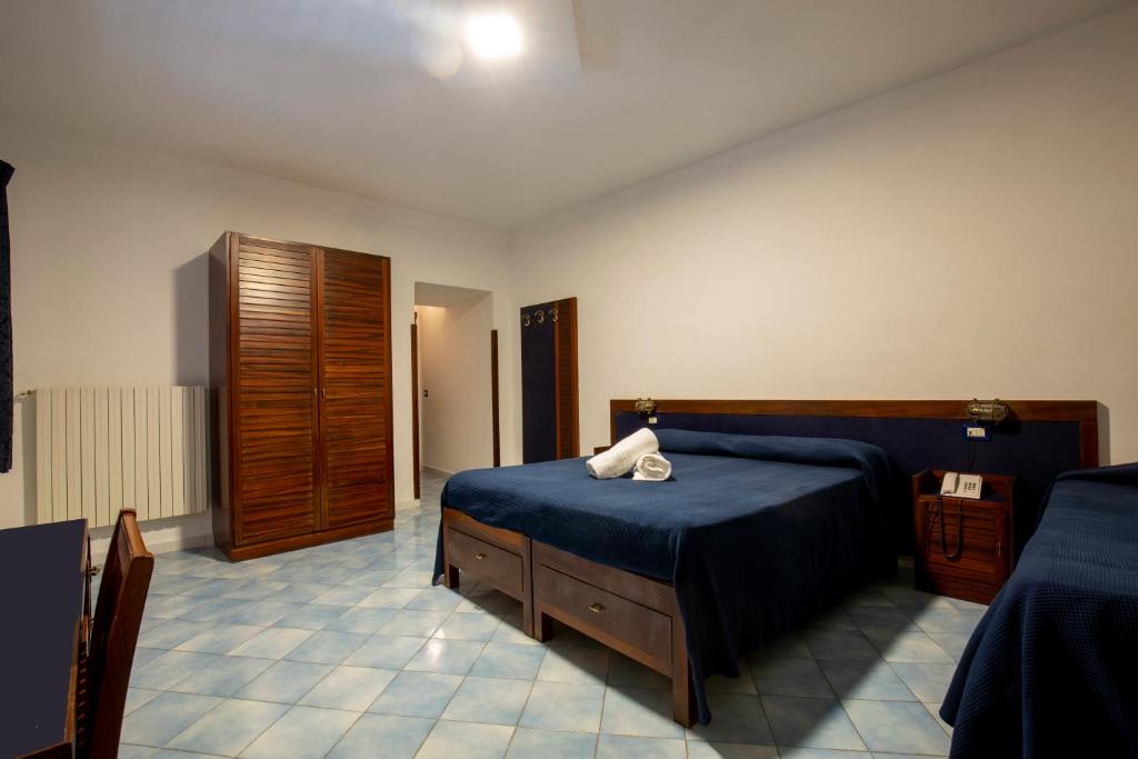 Postel nebo postele na pokoji v ubytování Hotel Il Faro