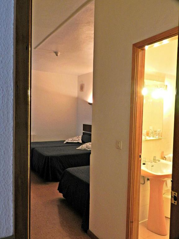 Postel nebo postele na pokoji v ubytování Hotel Val Flores