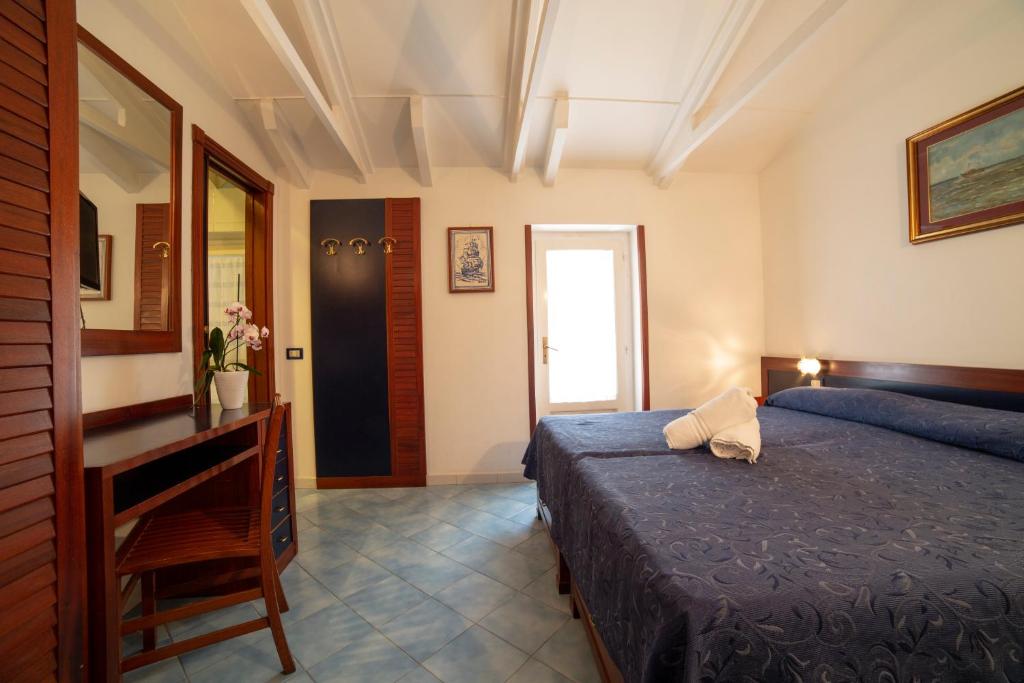 Postel nebo postele na pokoji v ubytování Hotel Il Faro