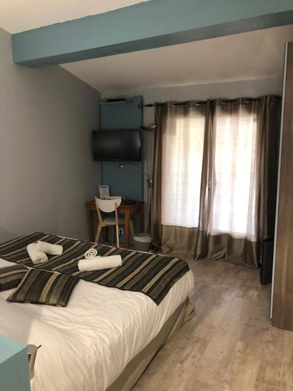 Postel nebo postele na pokoji v ubytování Le Mas Saint Donat