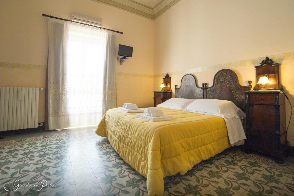 Postel nebo postele na pokoji v ubytování B&B Giardino Di Pietra