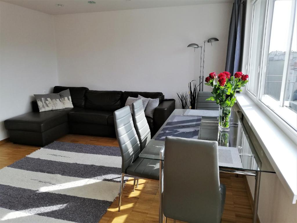 a living room with a glass table and a couch at Apartament Morski Integro in Sopot