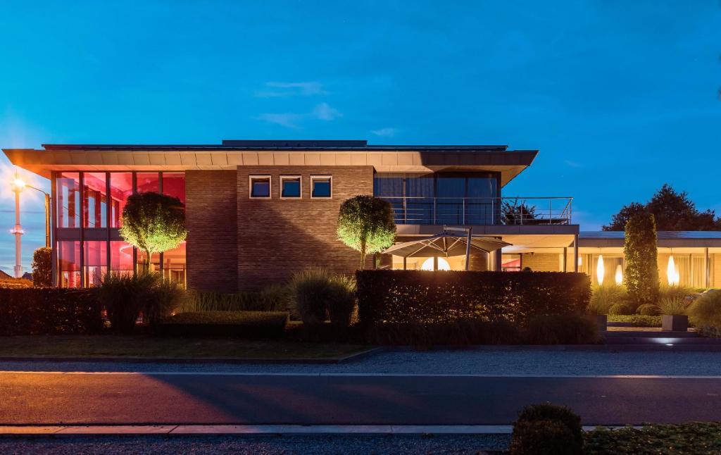 a building with a lit up facade at night at Espace Medissey in Bois-de-Villers