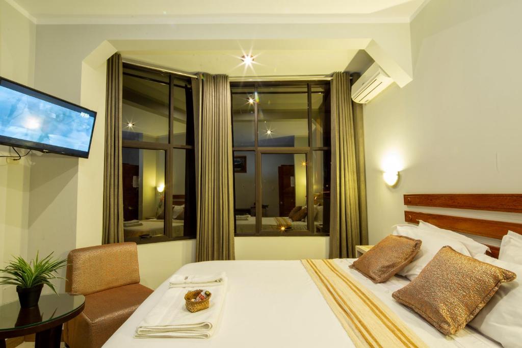 Postel nebo postele na pokoji v ubytování Sumaj Casa Hotel