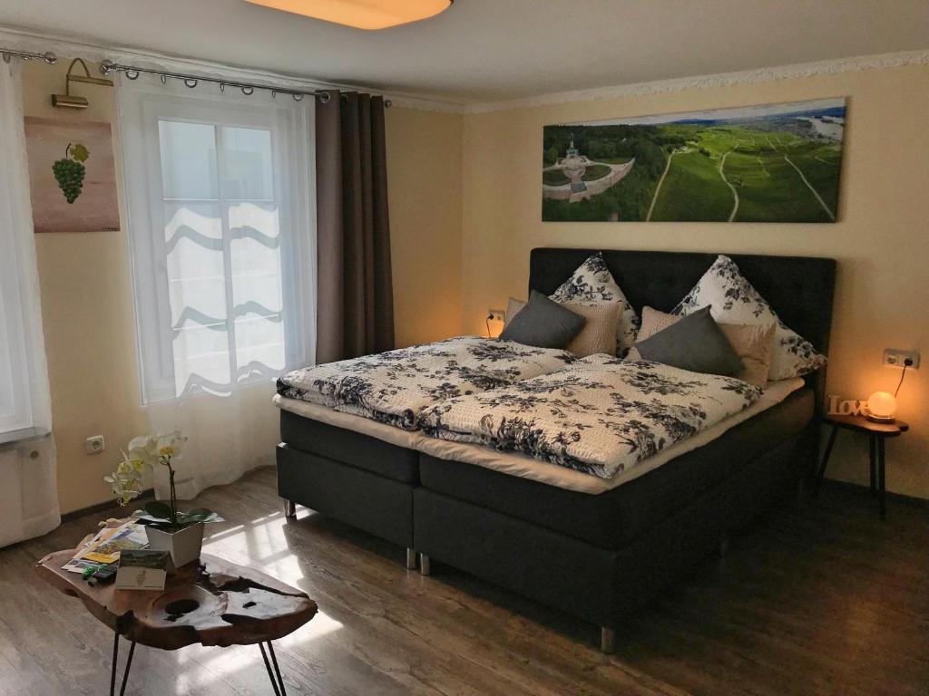 a bedroom with a bed and a table in it at Fewo Zur Goldenen Traube in Rüdesheim am Rhein