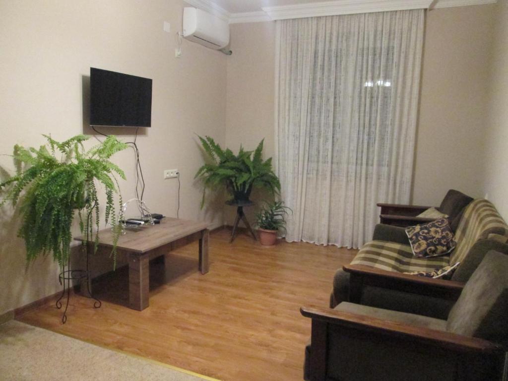 a living room with a couch and a table at Apartment Mandarina in K'obulet'i