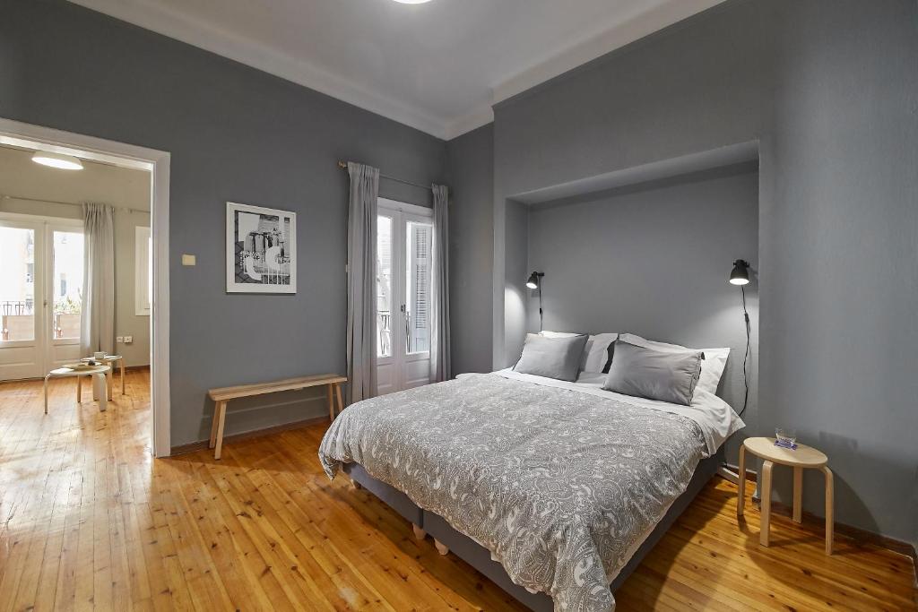 - une chambre avec un lit orné d'un mur gris dans l'établissement Bright Bright B Central Apartment with Balcony, à Thessalonique