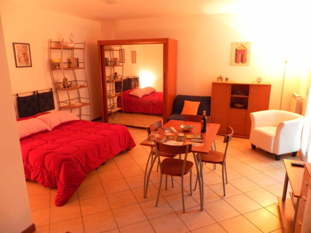 a bedroom with a bed and a table and a mirror at Appartamento Madonnina in Trieste