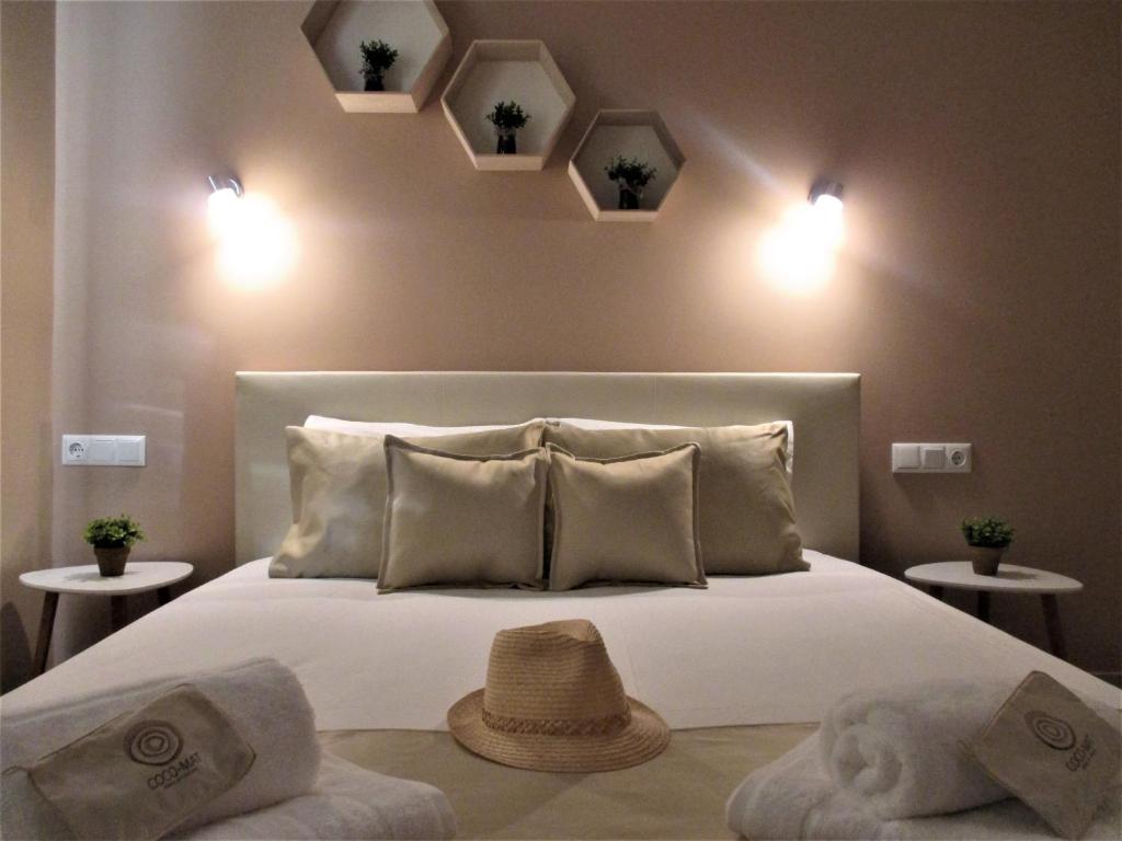 a bedroom with a bed with a hat on it at Jolen House in Skala Kallirachis