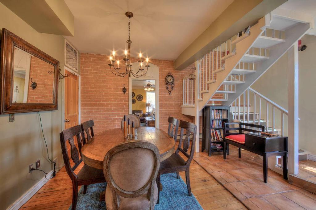 a dining room with a table and chairs and a staircase at Cali Cochitta Vacation Rentals in Moab