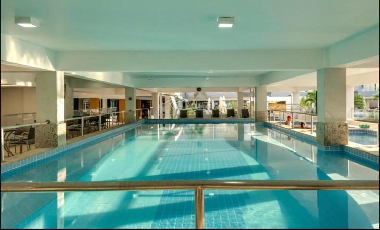 a large swimming pool in a large building at Apartamento Veredas do Rio Quente - 919 in Rio Quente