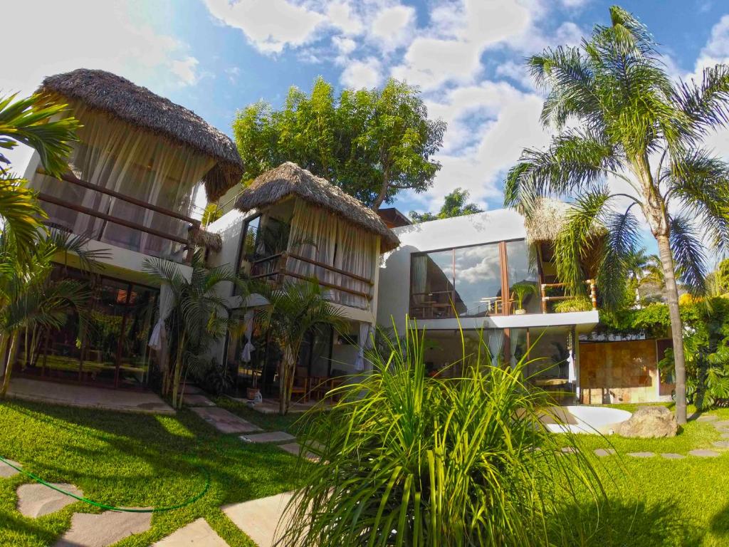 ein Resort mit Palmen und einem Gebäude in der Unterkunft Mocca Hotels in Tepoztlán