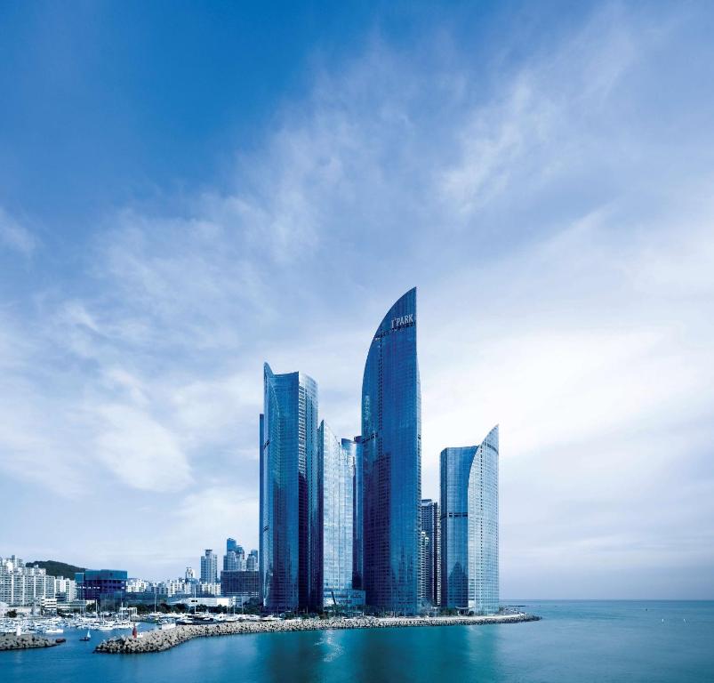 a city with tall buildings in the water at Park Hyatt Busan in Busan