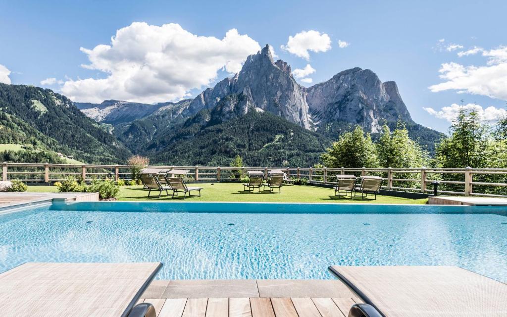 a swimming pool with a view of mountains at Sonus Alpis - Adults Only in Castelrotto