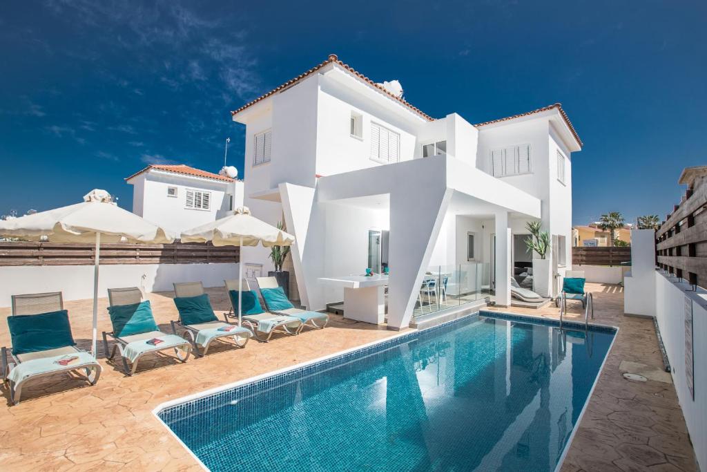 a villa with a swimming pool in front of a house at Marimar Luxury villa in Protaras