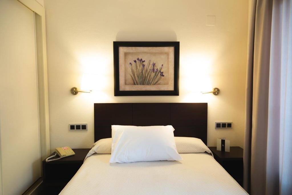 Postel nebo postele na pokoji v ubytování Hotel Cristina