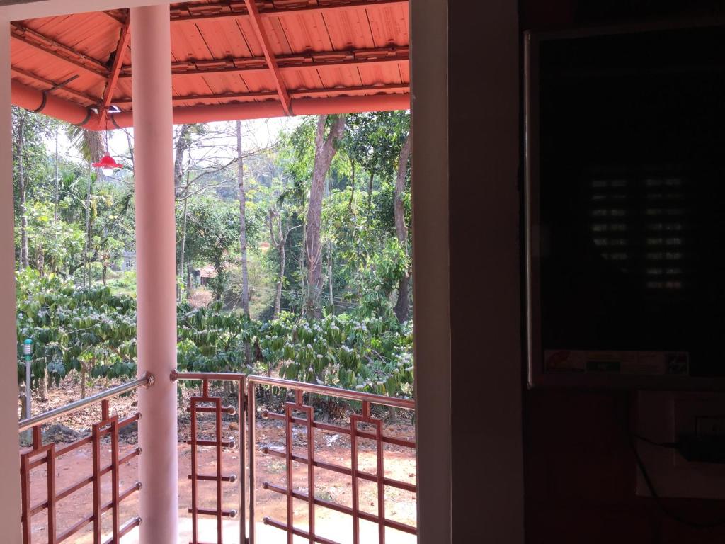 a view of a garden from a window at Marsim Holiday Resort in Vythiri
