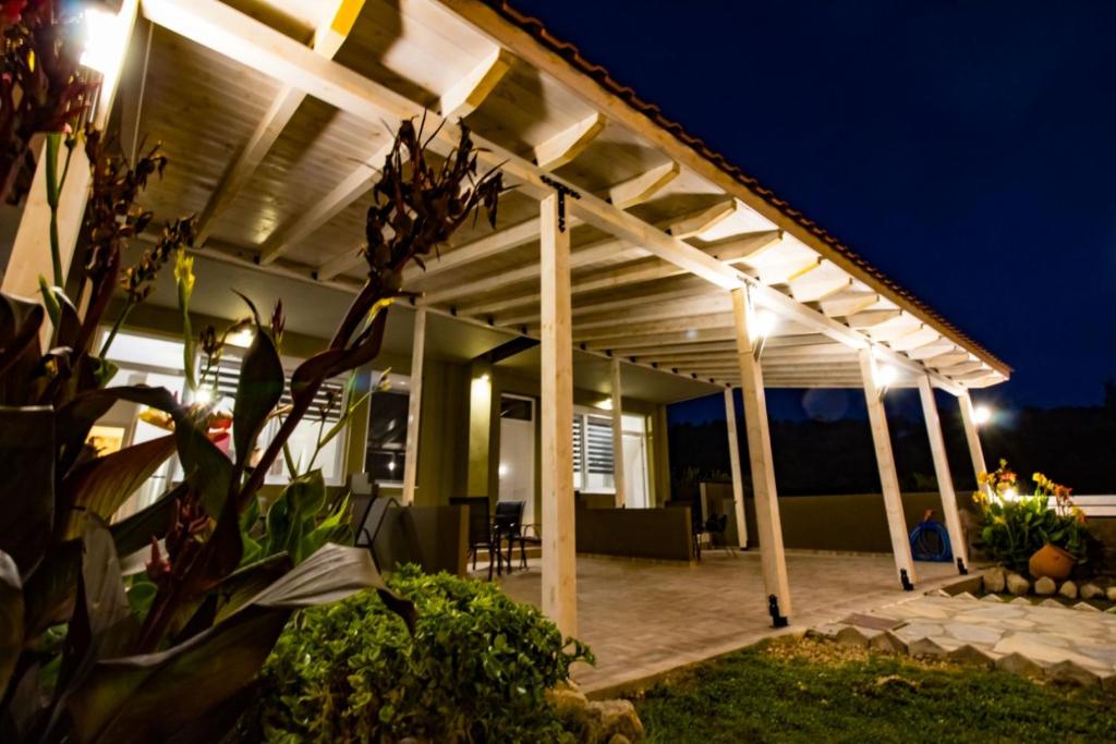 a pergola with lights on a house at night at Vickyvillas in Neos Marmaras