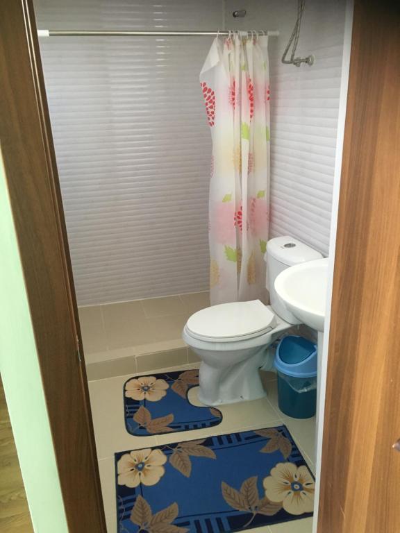 a bathroom with a toilet and a sink at AltynAi Guest House in Cholpon-Ata