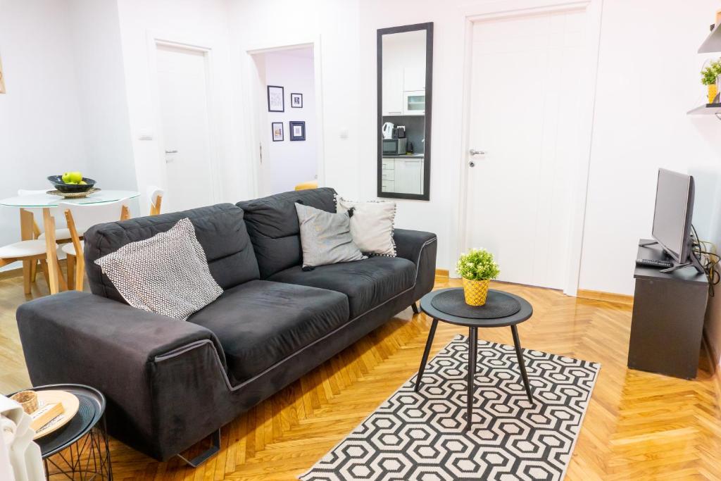 a living room with a couch and a table at Apartment Wake Up For 4 in Belgrade